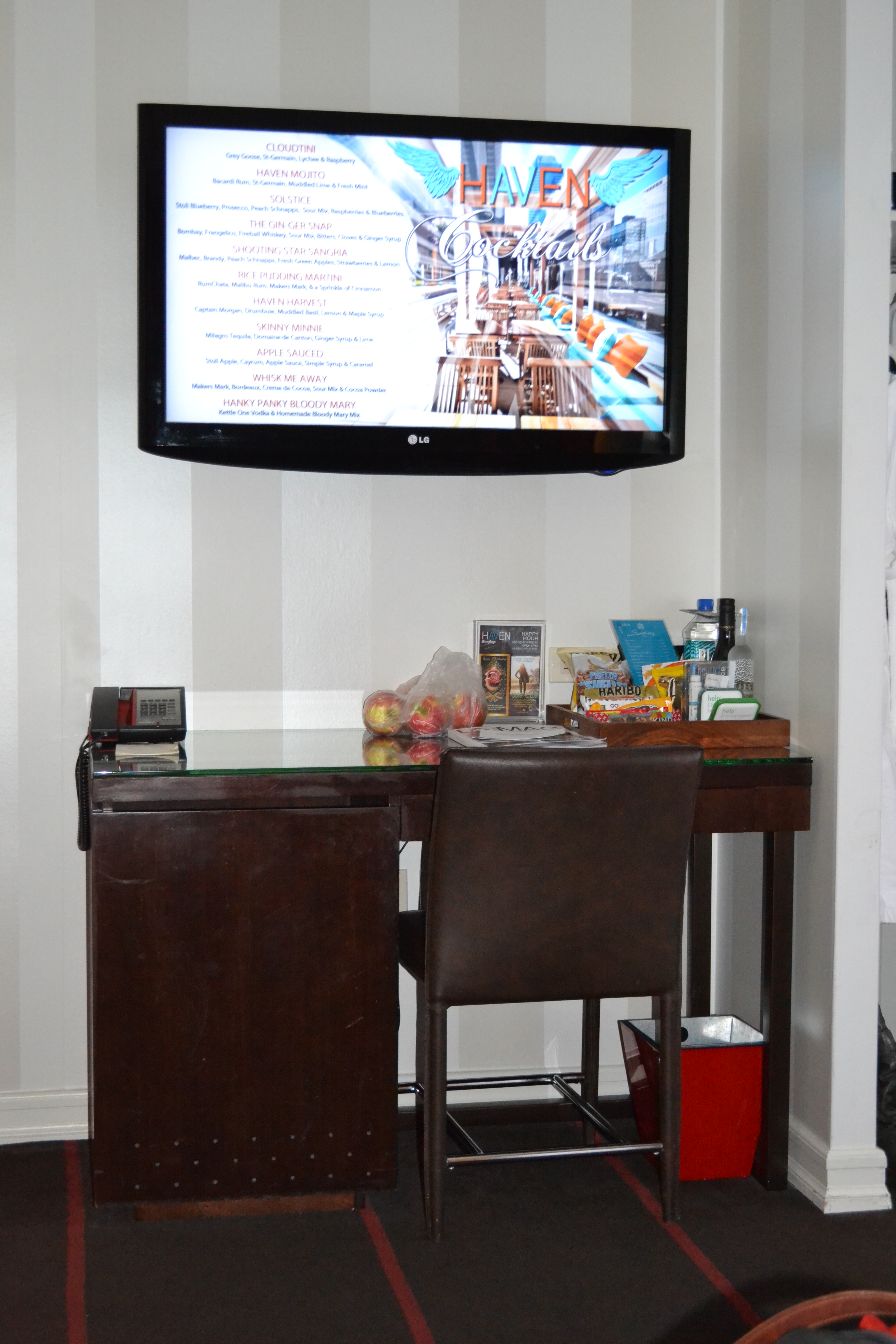 Wall TV with a desk and mini fridge